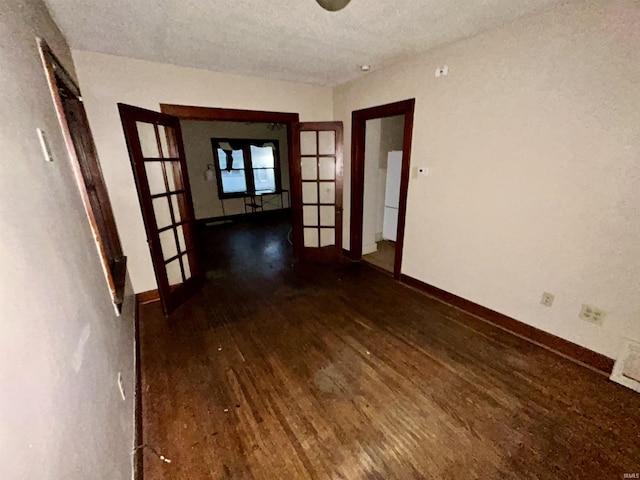312 Horace Mann Ct, Marion, IN 46952 - empty room featuring wood finished floors, french doors, baseboards, and a textured ceiling