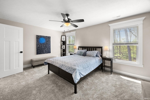 carpeted bedroom featuring baseboards and a ceiling fan