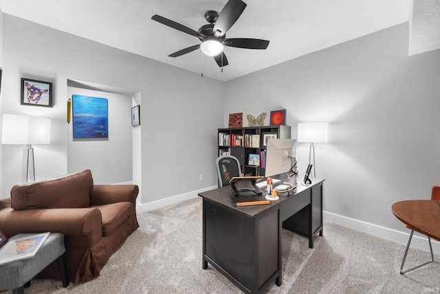 office with baseboards, light colored carpet, and ceiling fan