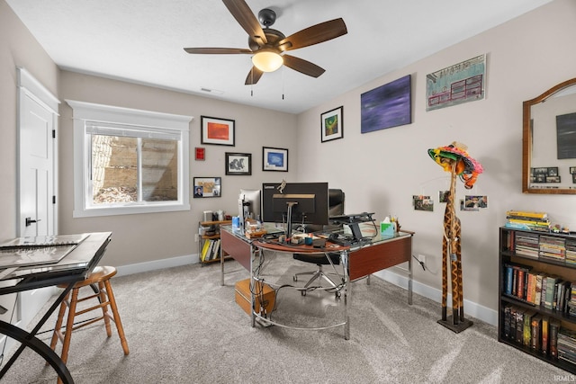 carpeted office featuring a ceiling fan and baseboards