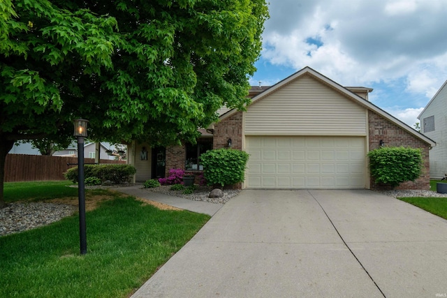 view of front of house with brick siding, a garage, and driveway