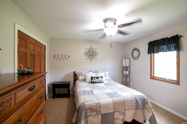 carpeted bedroom featuring baseboards and ceiling fan