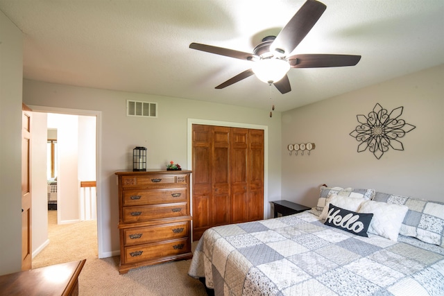 bedroom featuring light carpet, a closet, and ceiling fan