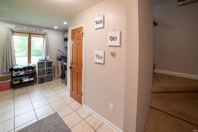hallway featuring light tile patterned floors, baseboards, and recessed lighting