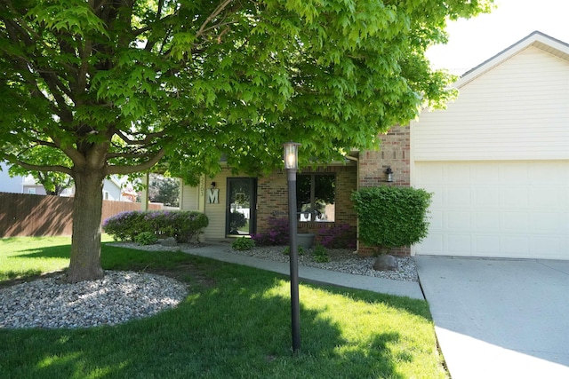 view of front of home with brick siding, an attached garage, and concrete driveway