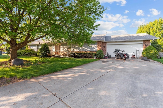 2704 President Ln, Kokomo, IN 46902 - view of front of property with driveway, brick siding, an attached garage, and a front yard