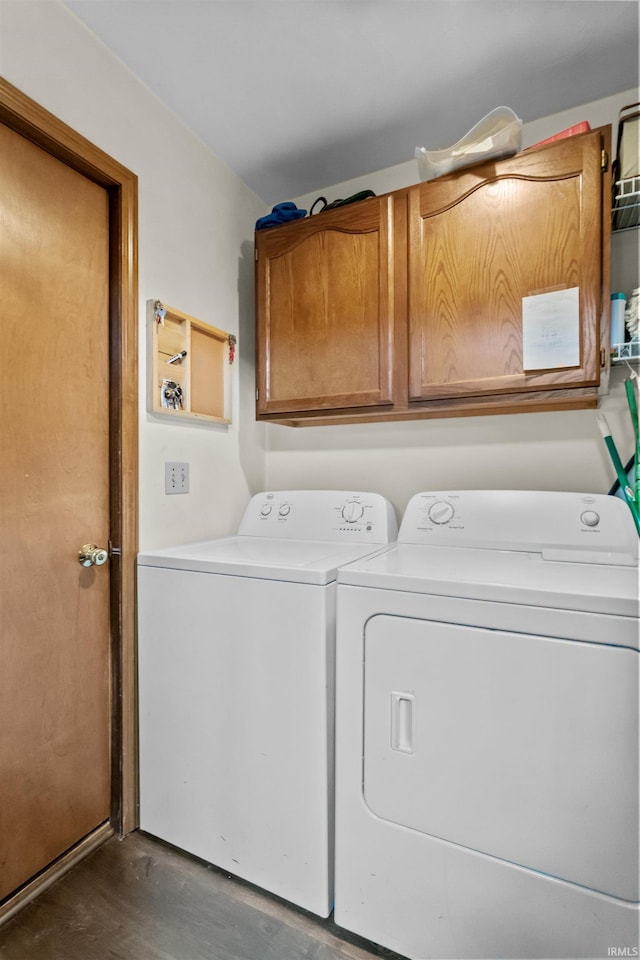 2704 President Ln, Kokomo, IN 46902 - clothes washing area featuring independent washer and dryer, cabinet space, and dark wood finished floors