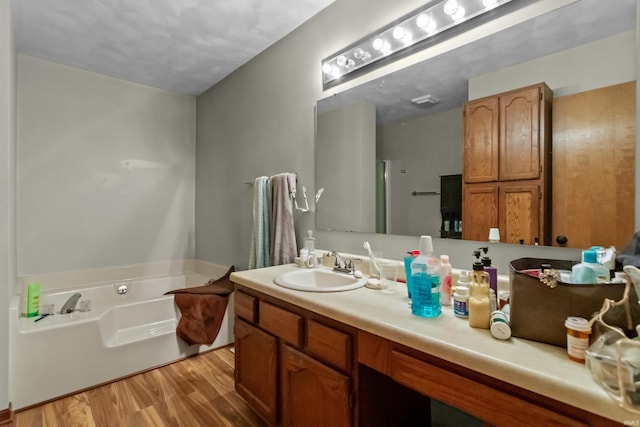 2704 President Ln, Kokomo, IN 46902 - bathroom with wood finished floors, a bath, vanity, and a shower with door