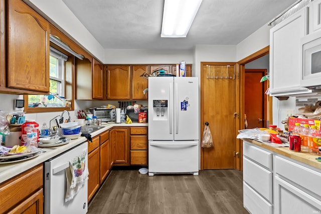 2704 President Ln, Kokomo, IN 46902 - kitchen with white appliances, a sink, light countertops, dark wood finished floors, and brown cabinetry