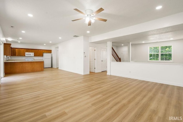 1041 Spring Mill Dr, Kokomo, IN 46902 - unfurnished living room with recessed lighting, light wood finished floors, stairs, ceiling fan, and baseboards