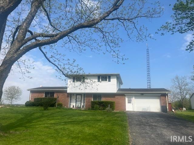 0421 S 200 W, Hartford City, IN 47348 - traditional-style home featuring brick siding, an attached garage, driveway, and a front lawn