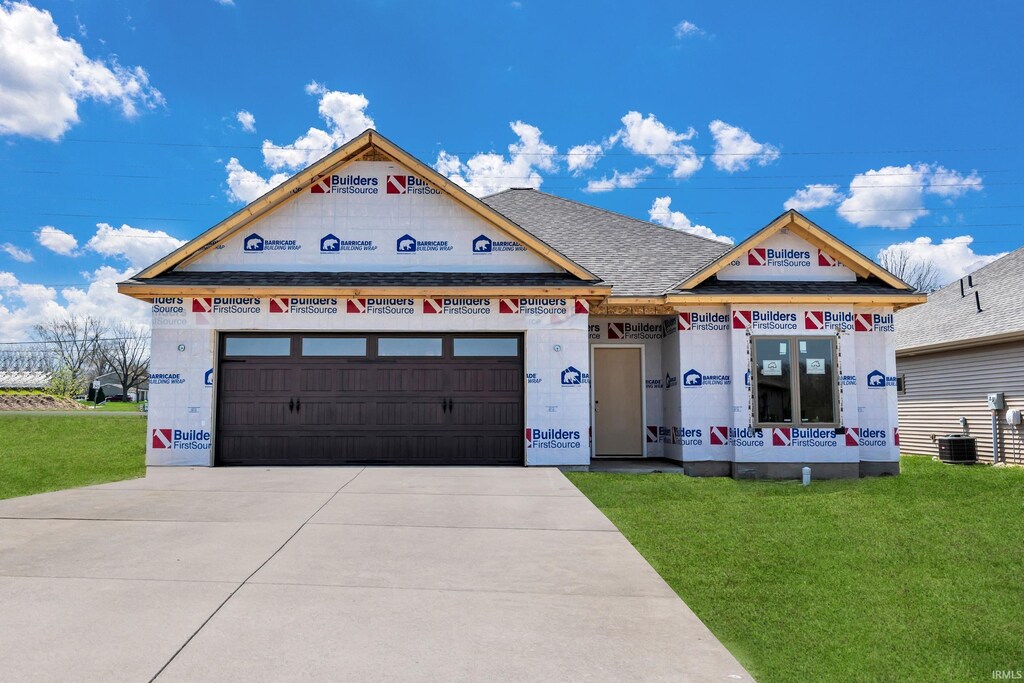 1176 Bunting Dr, Fort Wayne, IN 46825 - unfinished property featuring a front yard, an attached garage, driveway, central AC, and a shingled roof