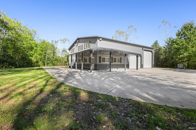 rear view of property with a lawn and a garage