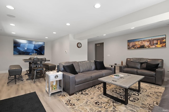 living area featuring light wood-style flooring, recessed lighting, and baseboards