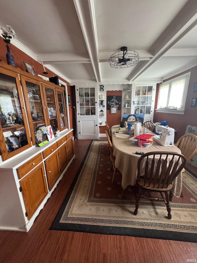 515 E Washington St, Attica, IN 47918 - dining space with dark wood-type flooring, beam ceiling, built in features, ornamental molding, and ceiling fan