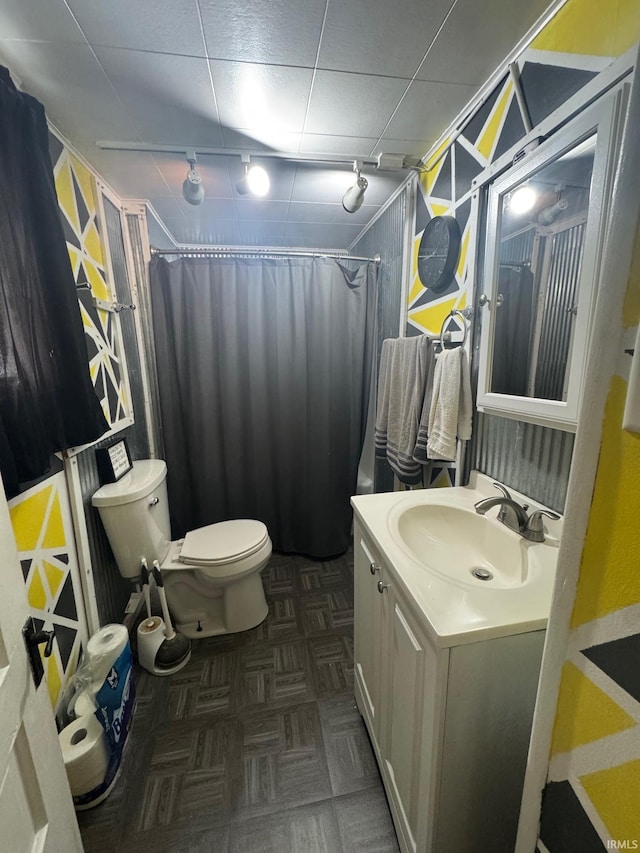 515 E Washington St, Attica, IN 47918 - bathroom with track lighting, toilet, vanity, and a shower with curtain