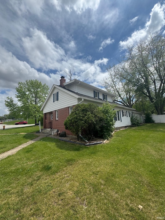 515 E Washington St, Attica, IN 47918 - view of side of home with a chimney and brick siding