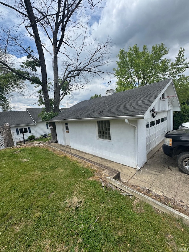 515 E Washington St, Attica, IN 47918 - view of property exterior with roof with shingles, a chimney, a yard, concrete block siding, and driveway
