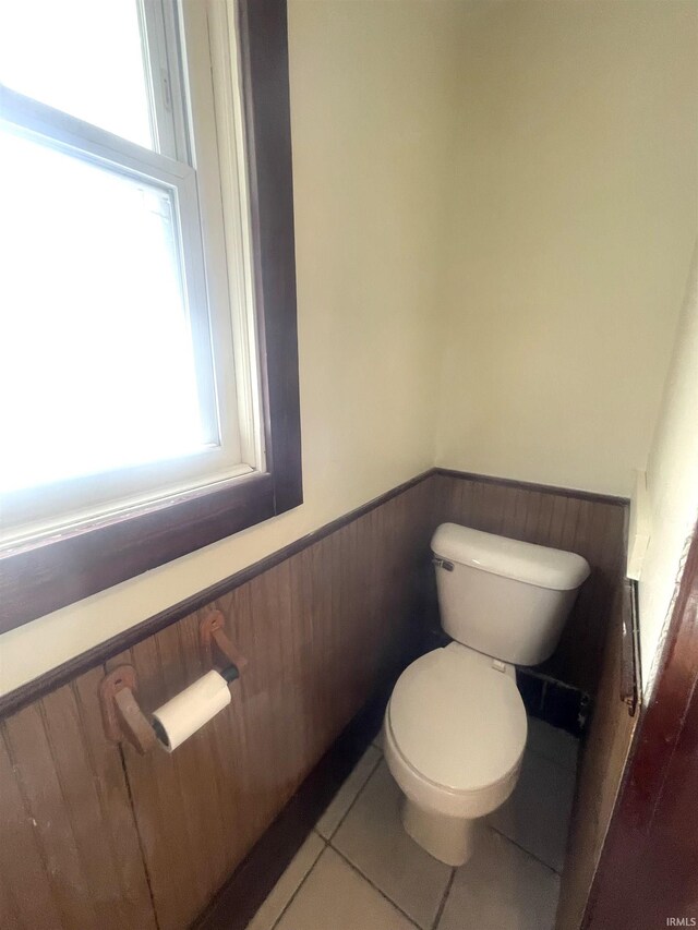 1307 High St, Logansport, IN 46947 - bathroom featuring a wainscoted wall, plenty of natural light, toilet, and tile patterned floors