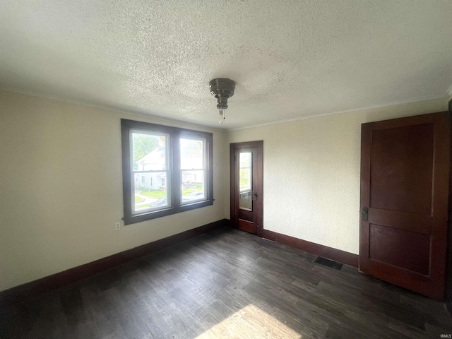 1307 High St, Logansport, IN 46947 - empty room with baseboards, a textured ceiling, dark wood finished floors, and crown molding