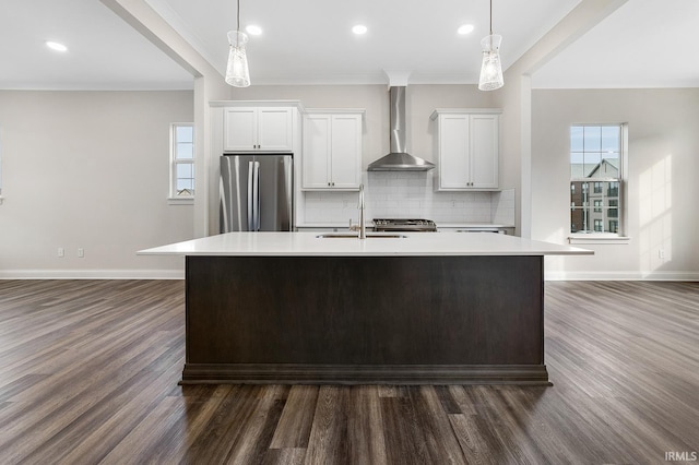 105 Parkerwood Ln, West Lafayette, IN 47906 - kitchen with freestanding refrigerator, wall chimney range hood, a sink, an island with sink, and dark wood-type flooring