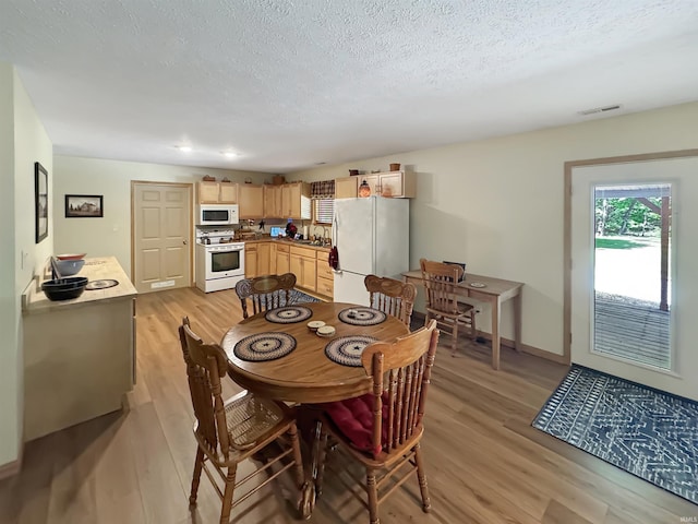 2548 N Letterman Rd, Paragon, IN 46166 - dining area featuring light wood finished floors, a textured ceiling, and baseboards