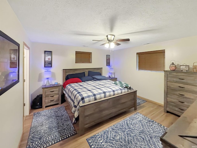 2548 N Letterman Rd, Paragon, IN 46166 - bedroom with light wood-style floors, a textured ceiling, a ceiling fan, and baseboards