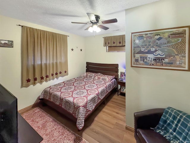 2548 N Letterman Rd, Paragon, IN 46166 - bedroom with wood finished floors, baseboards, a textured ceiling, and a ceiling fan