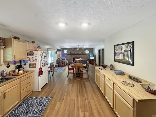 2548 N Letterman Rd, Paragon, IN 46166 - kitchen featuring freestanding refrigerator, light wood-style floors, open floor plan, a textured ceiling, and light brown cabinetry