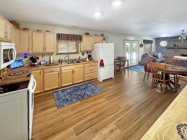 2548 N Letterman Rd, Paragon, IN 46166 - kitchen with white appliances, light brown cabinets, a sink, light wood-style flooring, and light countertops