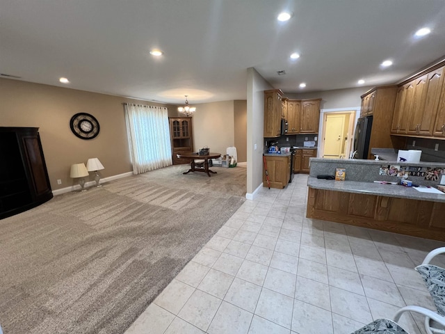 1155 N Fox Ridge Links Dr, Vincennes, IN 47591 - kitchen with light colored carpet, recessed lighting, fridge, light tile patterned floors, and baseboards