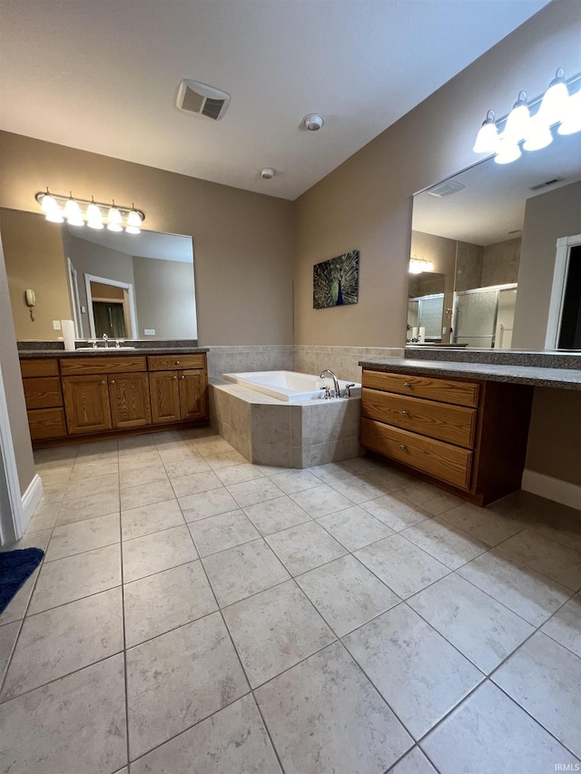 1155 N Fox Ridge Links Dr, Vincennes, IN 47591 - bathroom with tile patterned floors, a garden tub, a stall shower, and two vanities