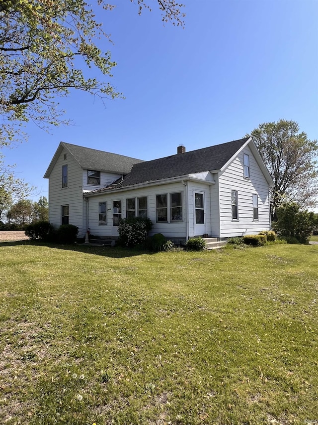 14310 Juniper Rd, Argos, IN 46501 - back of property featuring a lawn, a chimney, and a shingled roof