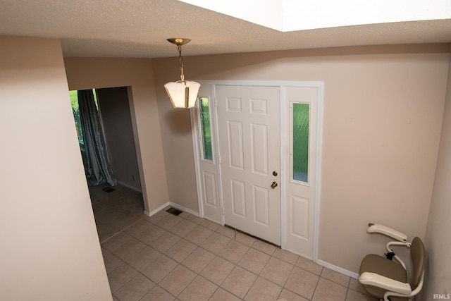 218 S 22nd St, Vincennes, IN 47591 - entrance foyer with light tile patterned flooring, baseboards, and a textured ceiling