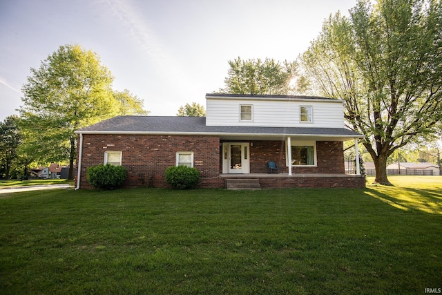 218 S 22nd St, Vincennes, IN 47591 - traditional-style home with a front yard, brick siding, covered porch, and a shingled roof