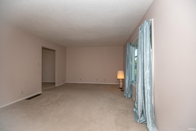 218 S 22nd St, Vincennes, IN 47591 - unfurnished room featuring a textured ceiling, light carpet, and baseboards