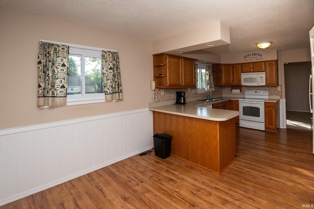 218 S 22nd St, Vincennes, IN 47591 - kitchen with white appliances, a sink, brown cabinets, open shelves, and a peninsula