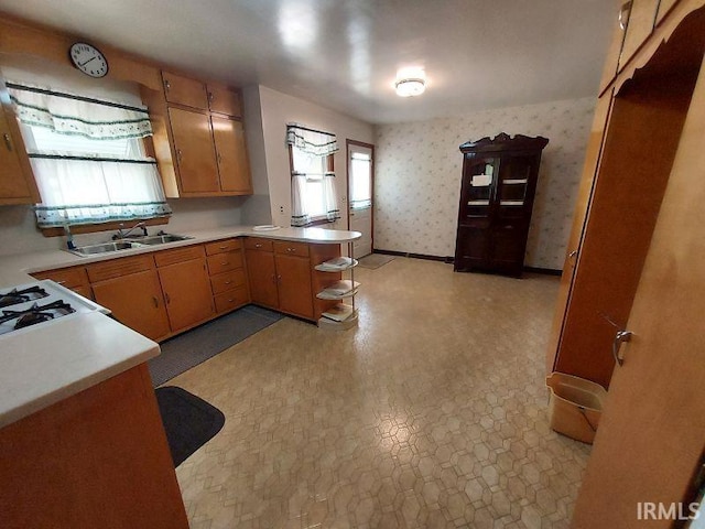 1800 N 350 W, Jasper, IN 47546 - kitchen with a sink, light countertops, a peninsula, stovetop, and wallpapered walls