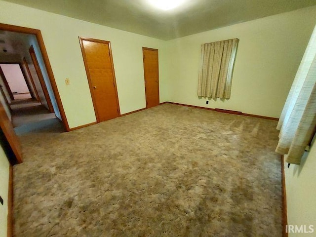 1800 N 350 W, Jasper, IN 47546 - unfurnished bedroom with carpet, multiple closets, and baseboards