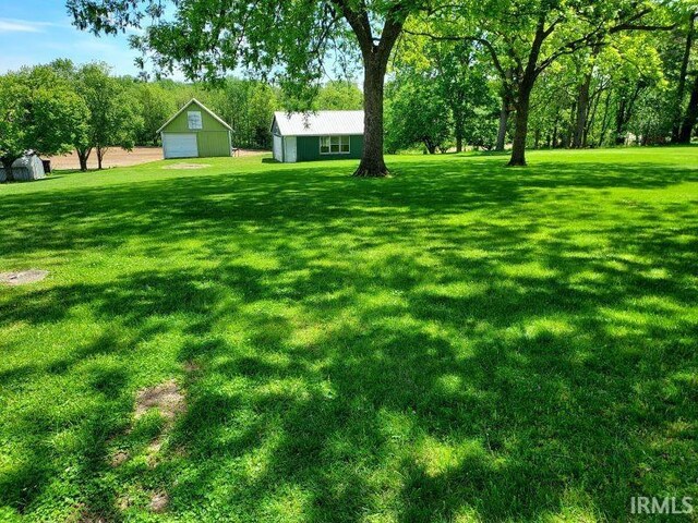 1800 N 350 W, Jasper, IN 47546 - view of grassy yard with an outbuilding and a garage