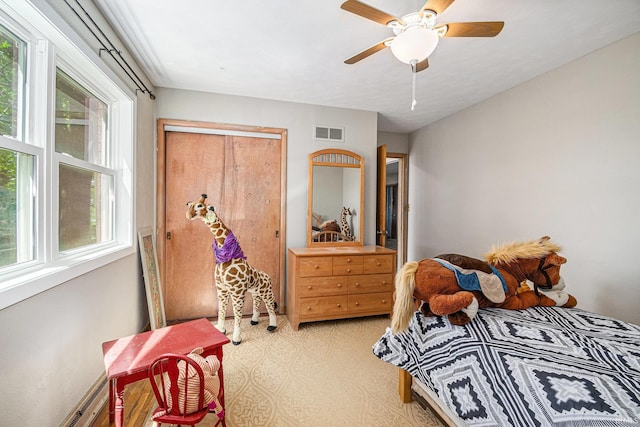 bedroom featuring light carpet and ceiling fan