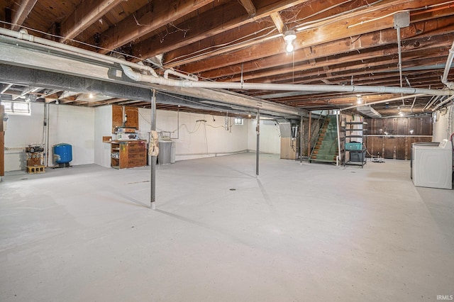 below grade area with a water pressure tank and washer and dryer