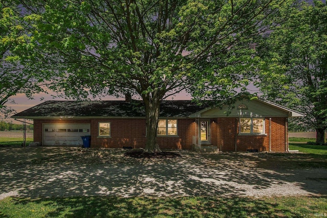 view of front of property with a garage, brick siding, and driveway