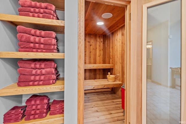 relaxing sauna / steam room with wood ceiling and recessed lighting