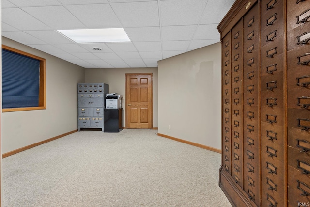 unfurnished room with carpet, baseboards, and a drop ceiling