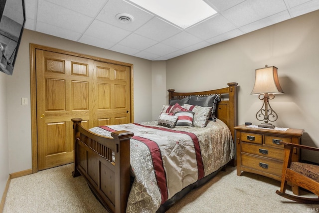 carpeted bedroom with a paneled ceiling