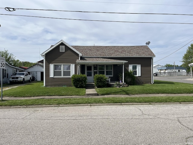 502 W Vantrees St, Washington, IN 47501 - view of front of home with covered porch, a front yard, and roof with shingles