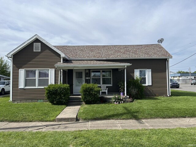502 W Vantrees St, Washington, IN 47501 - view of front of house with covered porch, a front yard, and roof with shingles
