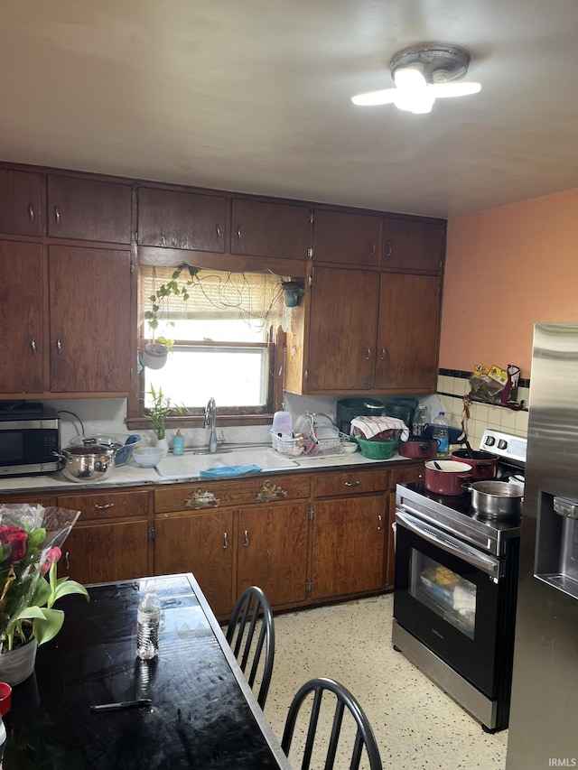 502 W Vantrees St, Washington, IN 47501 - kitchen featuring appliances with stainless steel finishes, a sink, and light countertops