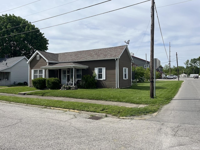 502 W Vantrees St, Washington, IN 47501 - view of front of house featuring a front lawn and a shingled roof